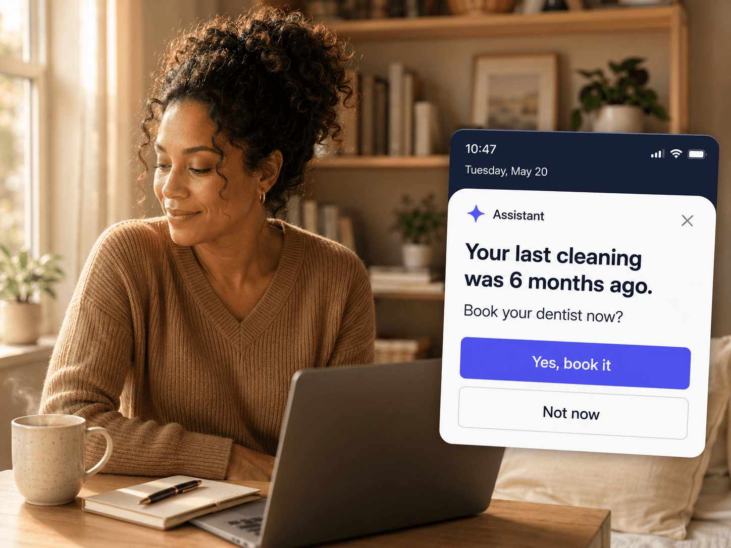 A woman working at her laptop at home. An assistant notification at 10:47 reads Your last cleaning was 6 months ago, book your dentist now, with a Yes, book it button.